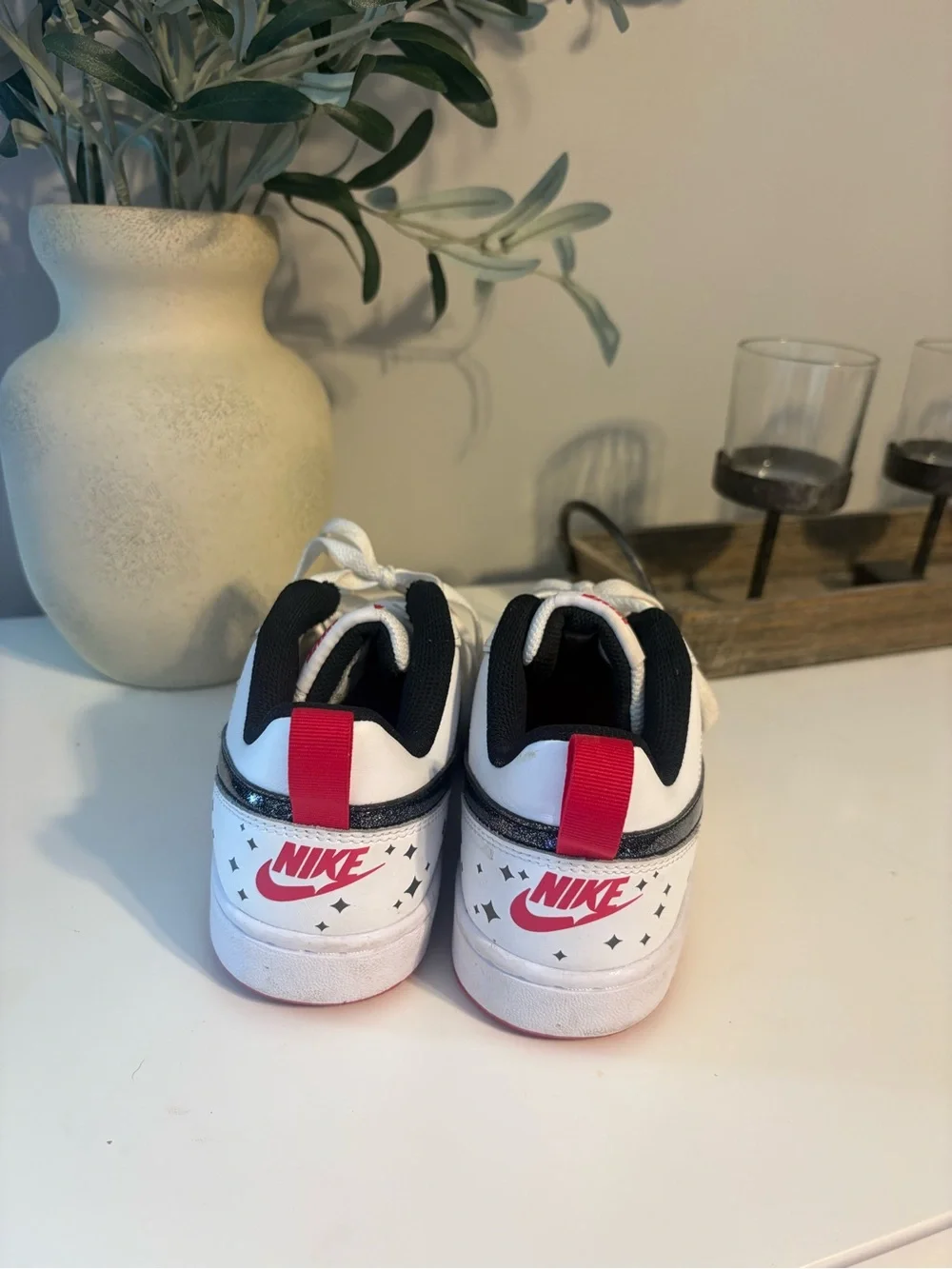 Nike White Low-Top Sneakers with Sparkly Black Swoosh and Red Accents